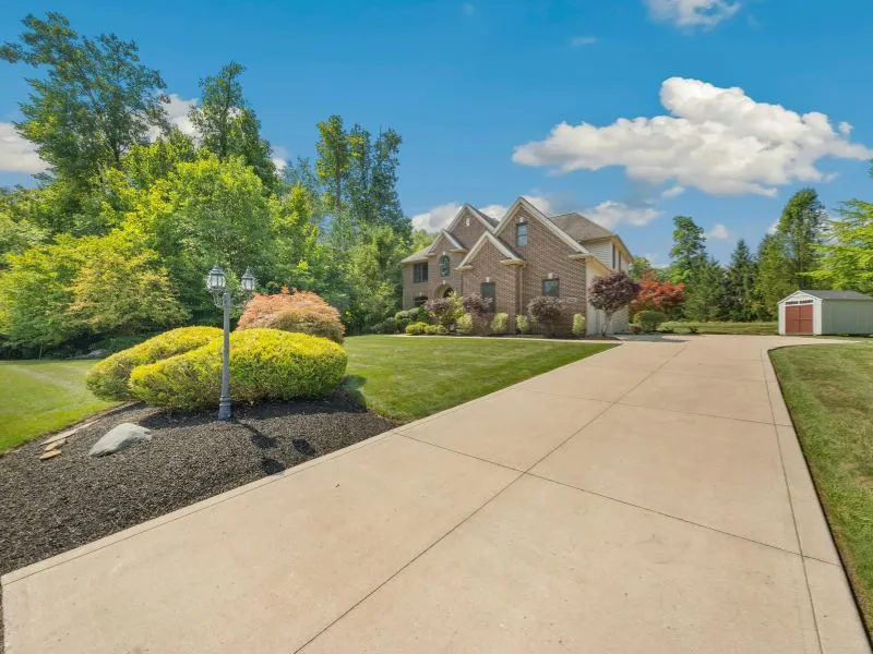 Paved driveway with shrubs provided by concrete contractors durham nc.