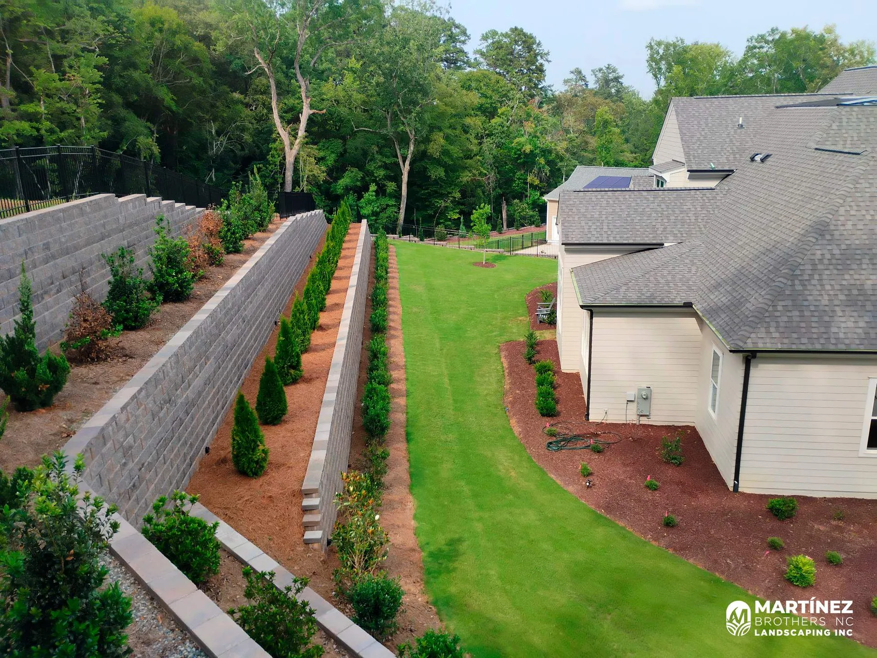 Retaining wall and landscape beds on a Durham property