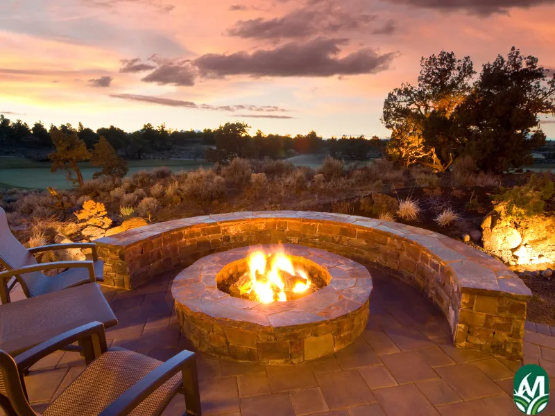 A wood burning fire pit at sunset.